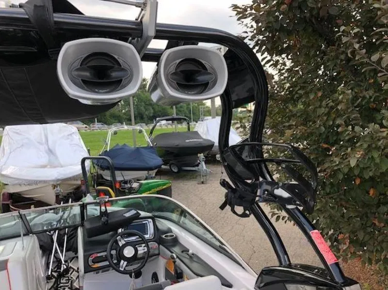 Slide: The Image of 2013 Nautique Super Air Nautique 230 boat with tower speakers and steering wheel. - 9