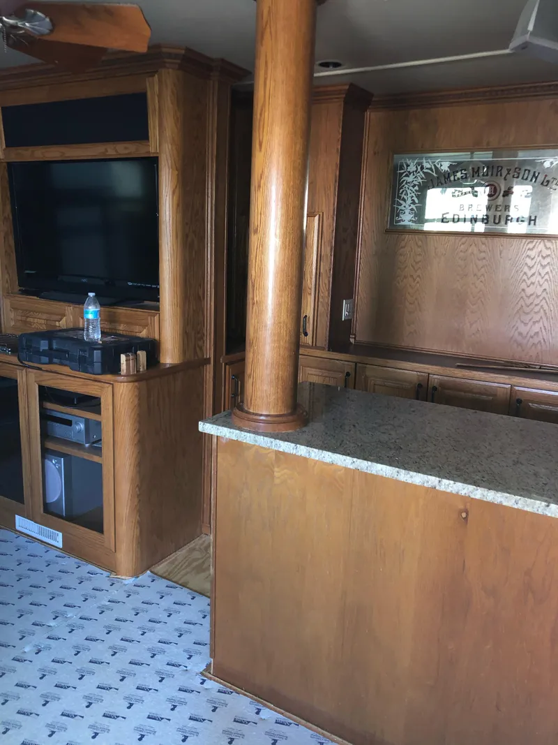 Slide: The Image of Interior of 2004 Sumerset Wind Walker with wood cabinetry and granite countertop. - 11