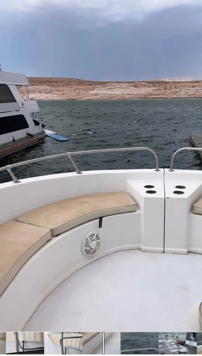 Slide: The Image of 2004 Sumerset Wind Walker boat with seating, on a lake with a distant shoreline. - 13