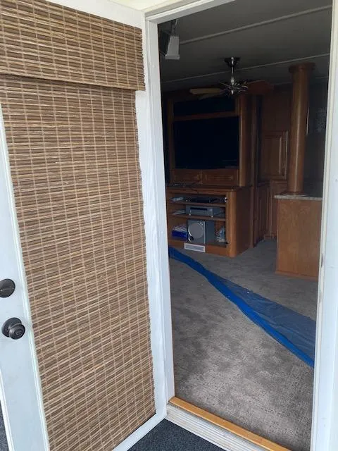 Slide: The Image of Interior view of 2004 Sumerset Wind Walker houseboat with carpet and entertainment center. - 19