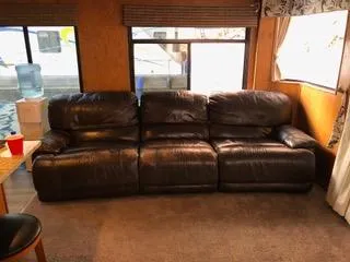 Slide: The Image of Brown leather sofa inside 2004 Sumerset Wind Walker houseboat. - 2