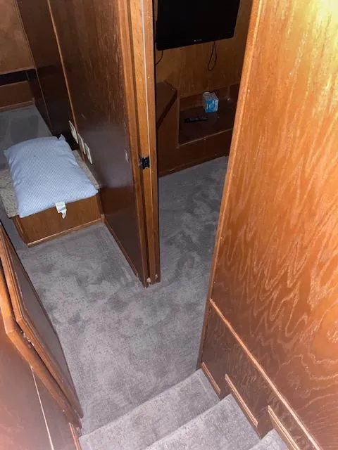 Slide: The Image of Interior of 2004 Sumerset Wind Walker houseboat with wooden walls and carpeted floor. - 22