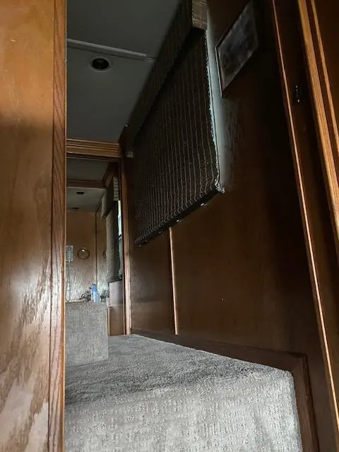 Slide: The Image of Interior view of 2004 Sumerset Wind Walker houseboat with wooden paneling and cozy seating. - 23