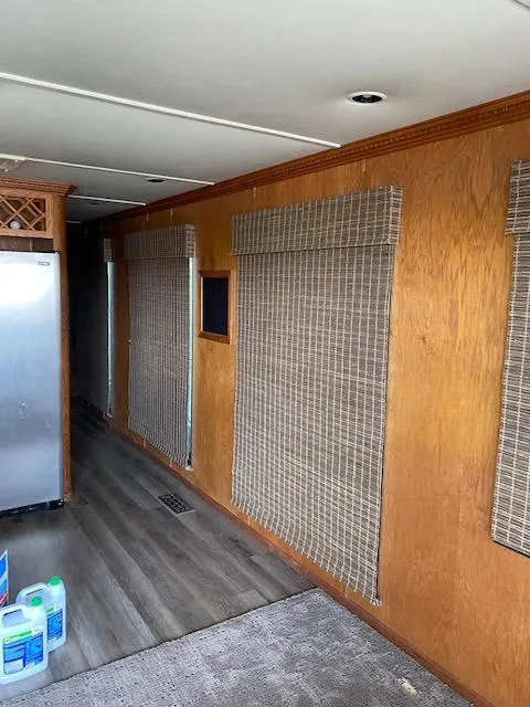 Slide: The Image of Interior of 2004 Sumerset Wind Walker houseboat with wooden walls and blinds. - 25