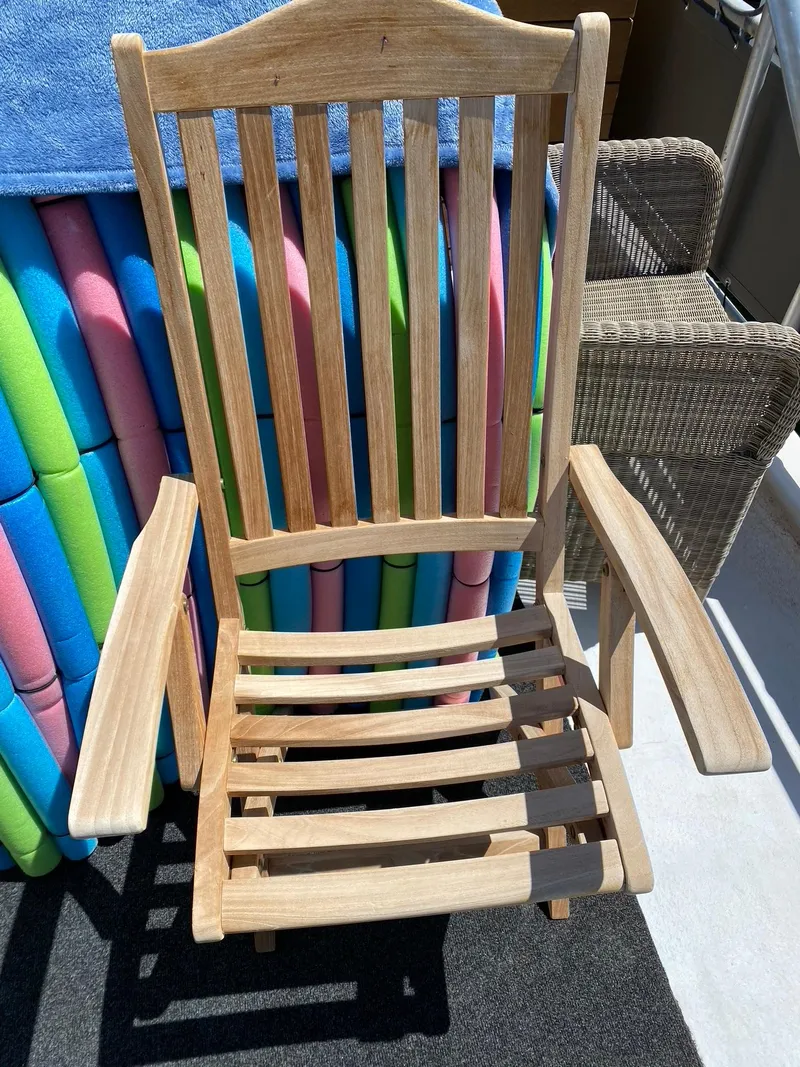 Slide: The Image of Wooden chair with slatted design, next to colorful pool noodles. - 29