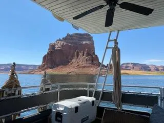 Slide: The Image of 2004 Sumerset Wind Walker houseboat with scenic lake and rock formation view. - 4