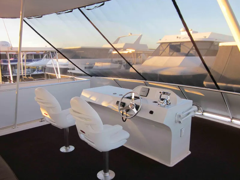 Slide: The Image of Helm of 2011 Bravada Knot A Problem Share 6 yacht with two white captain chairs. - 14
