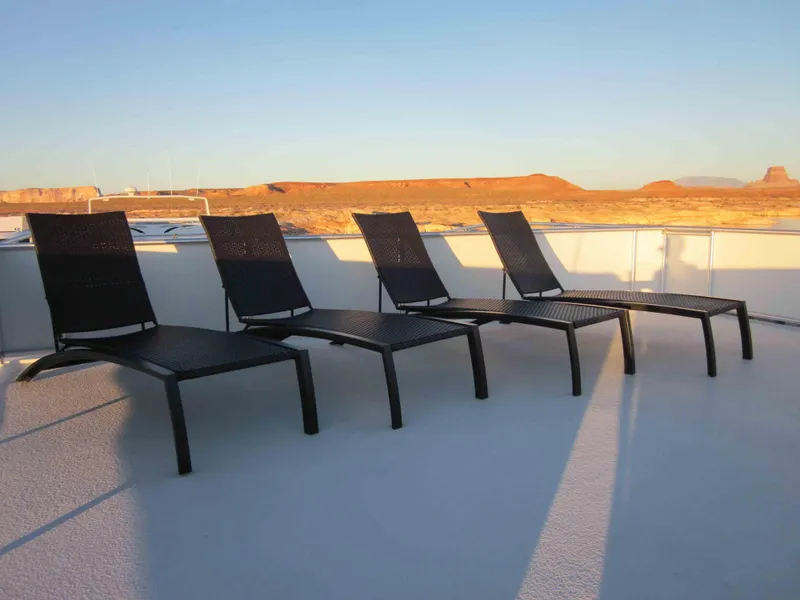 Slide: The Image of Four black lounge chairs on a Bravada Knot A Problem Share 6 houseboat deck, 2011 model. - 15