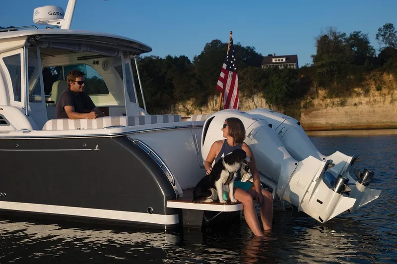 Slide: The Image of 2024 Back Cove 34O boat with people and dog on water. - 12