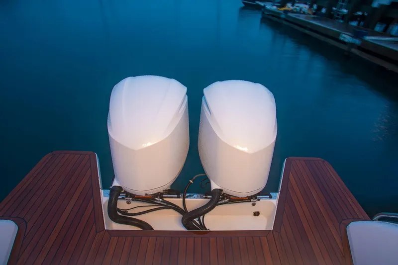 Slide: The Image of 2024 Back Cove 34O with twin outboard engines at dock. - 13
