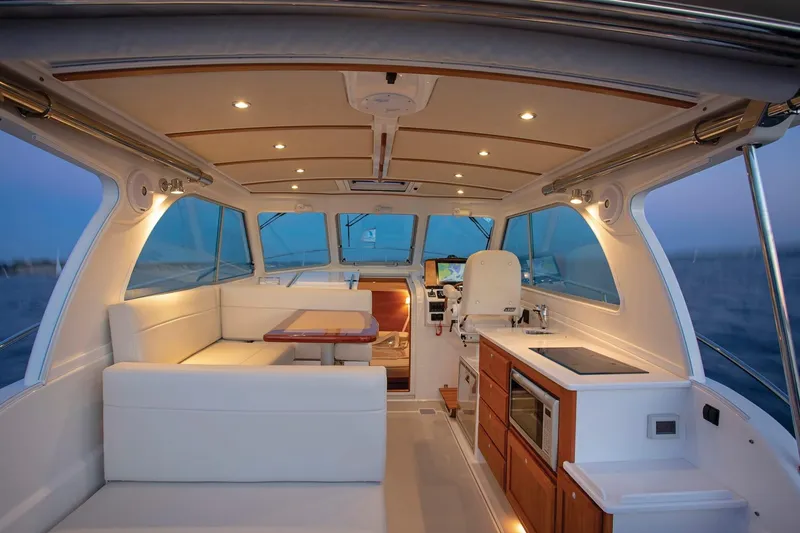 Slide: The Image of Interior of 2024 Back Cove 34O yacht with modern kitchen and seating area. - 16