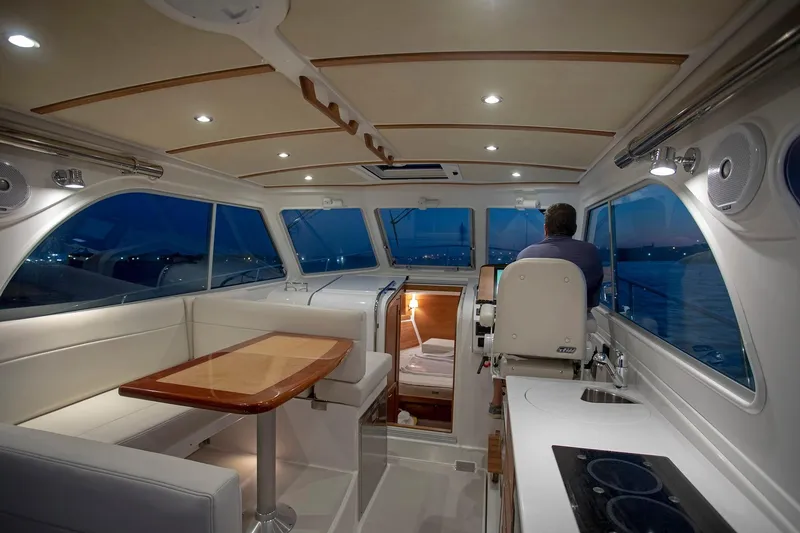 Slide: The Image of Interior of 2024 Back Cove 34O yacht with modern seating and dining area. - 19