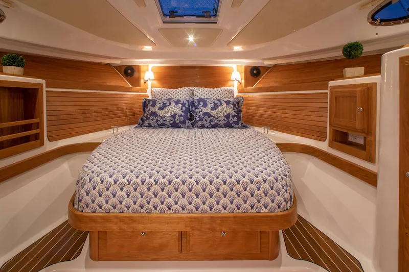 Slide: The Image of Luxurious cabin interior of 2024 Back Cove 34O yacht with cozy bed and wooden accents. - 22