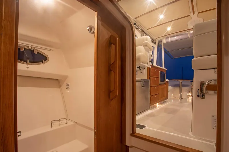 Slide: The Image of Interior of 2024 Back Cove 34O boat with modern design and wooden accents. - 29