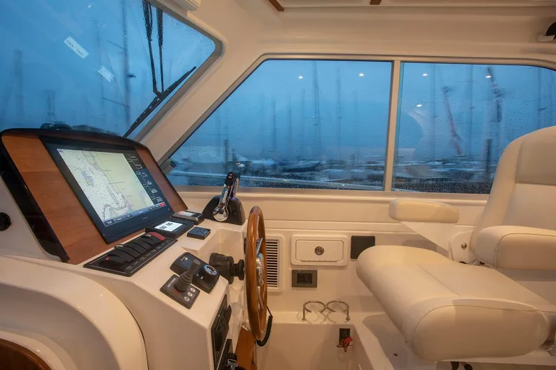 Slide: The Image of 2024 Back Cove 34O helm with navigation system and captain's chair. - 30
