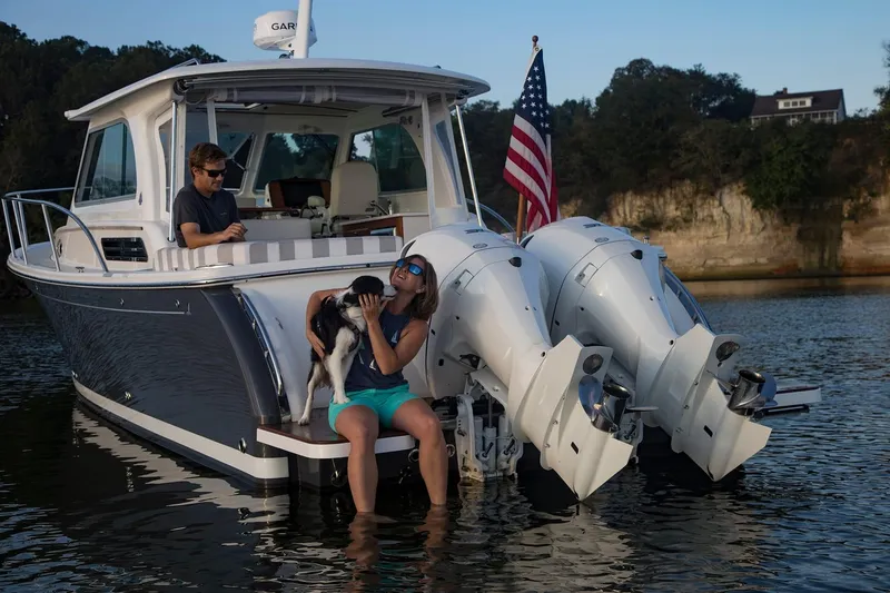Slide: The Image of 2024 Back Cove 34O boat with people and dog on water. - 5