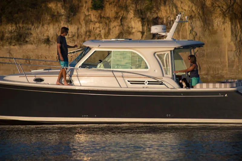 Slide: The Image of 2024 Back Cove 34O boat cruising with two people onboard. - 9