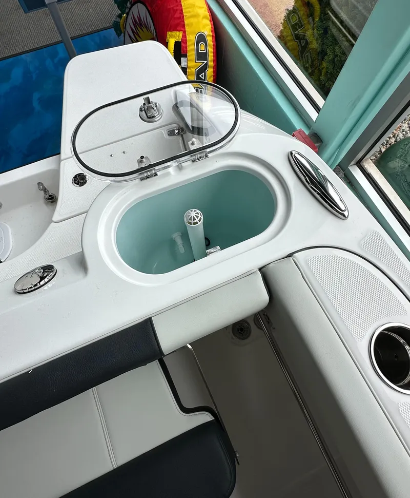 Slide: The Image of 2025 Edgewater 230CC Center Console boat interior with livewell and seating area. - 11