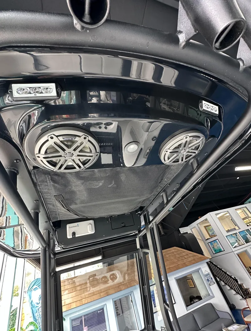 Slide: The Image of 2025 Edgewater 230CC Center Console boat with advanced audio system and sleek design. - 16