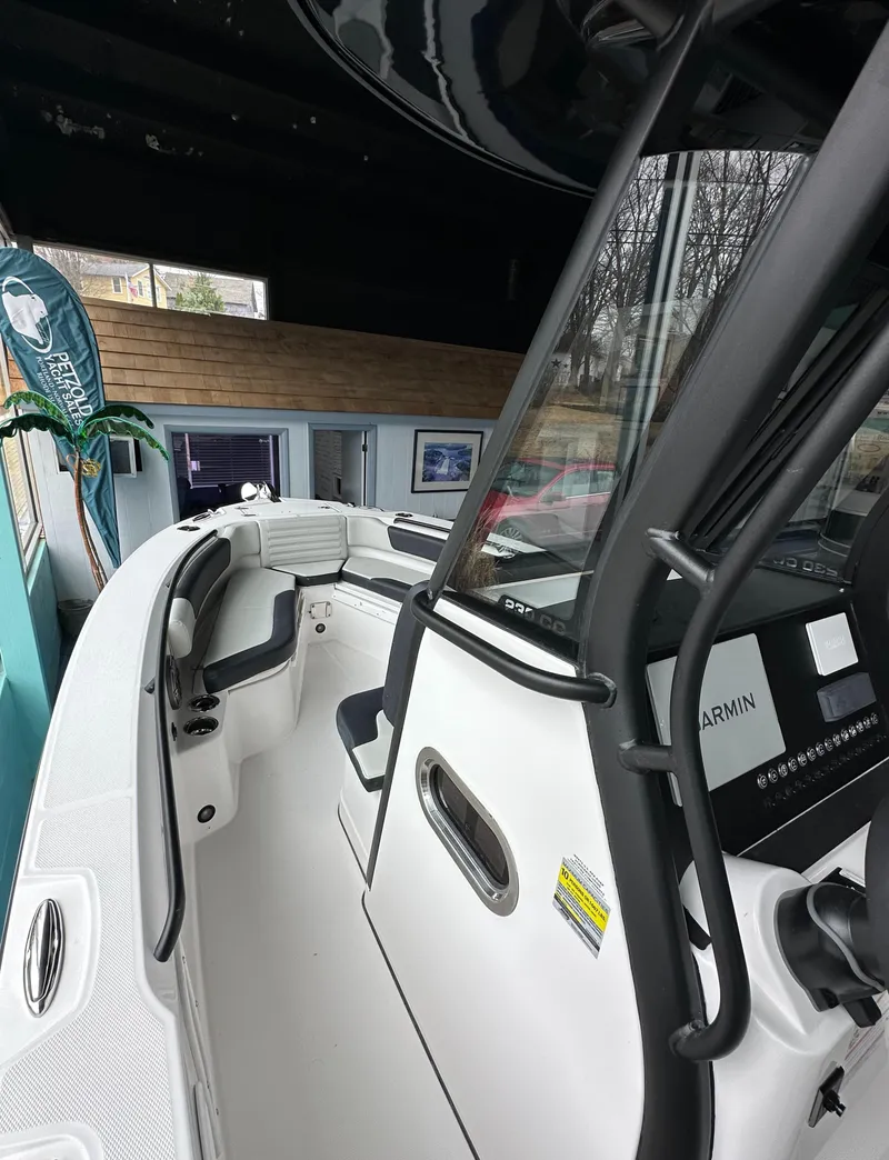 Slide: The Image of 2025 Edgewater 230CC Center Console boat interior with modern controls and seating. - 18