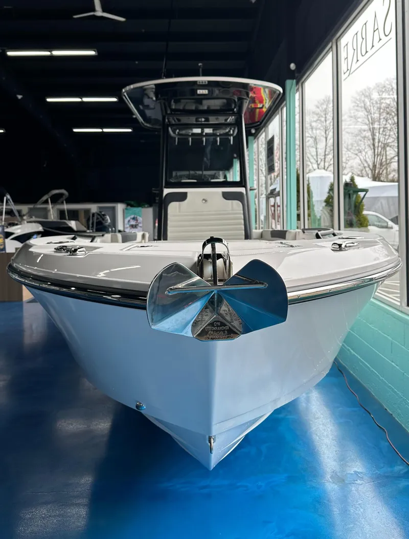 Slide: The Image of 2025 Edgewater 230CC Center Console boat in showroom, front view. - 2