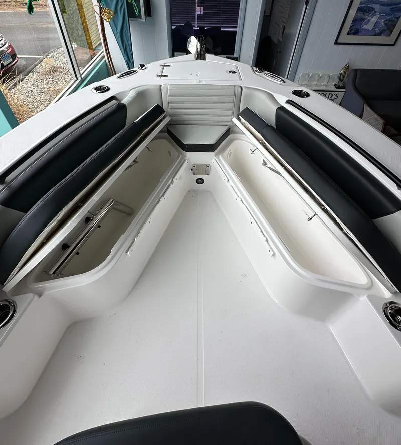 Slide: The Image of 2025 Edgewater 230CC Center Console boat interior with open storage compartments. - 21