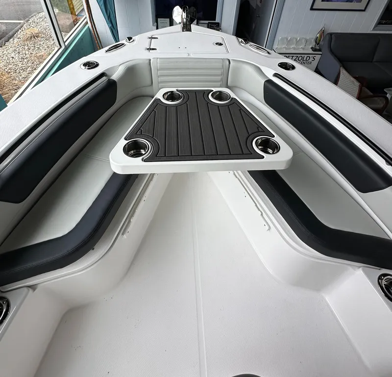 Slide: The Image of 2025 Edgewater 230CC Center Console boat interior with seating and cup holders. - 22