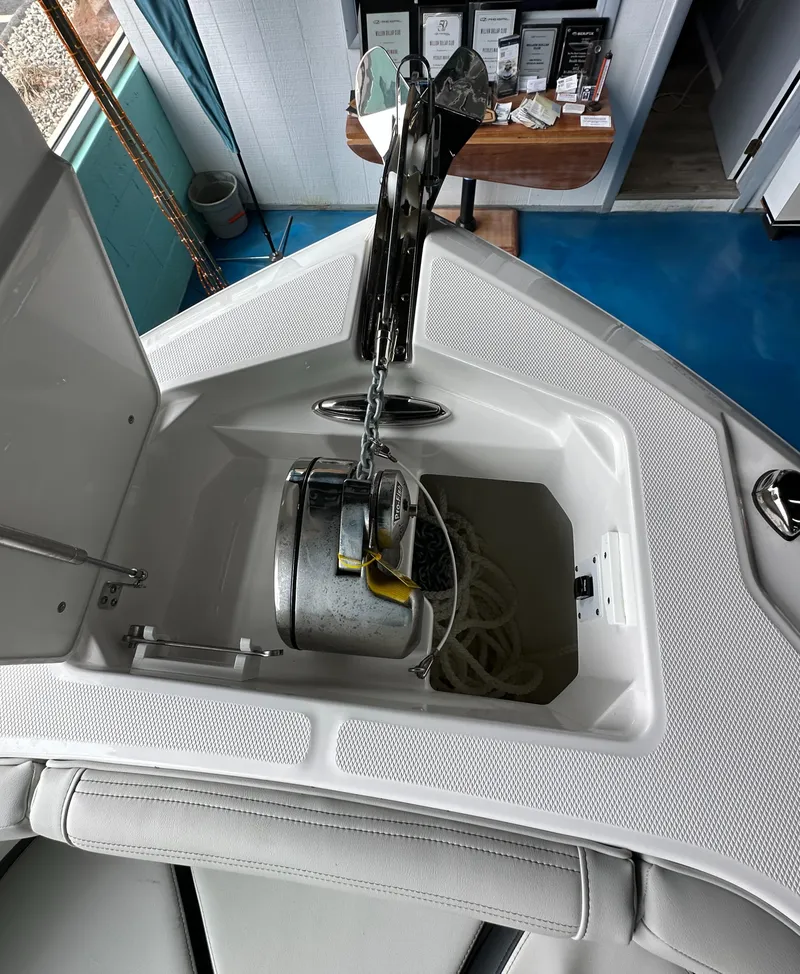 Slide: The Image of Anchor storage compartment on 2025 Edgewater 230CC Center Console boat. - 25
