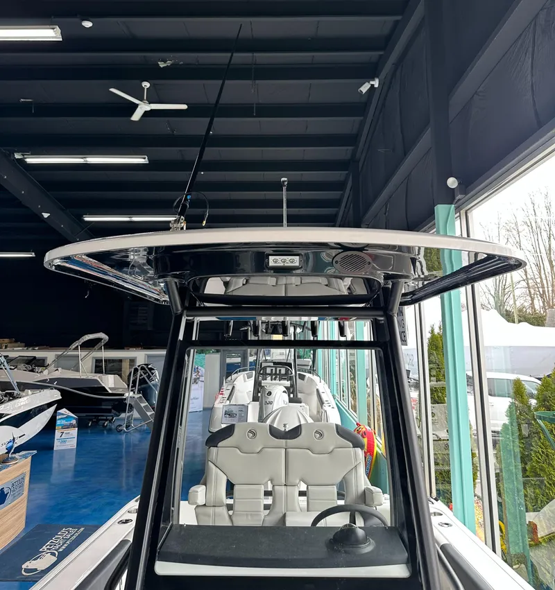 Slide: The Image of 2025 Edgewater 230CC Center Console boat displayed in a showroom. - 27