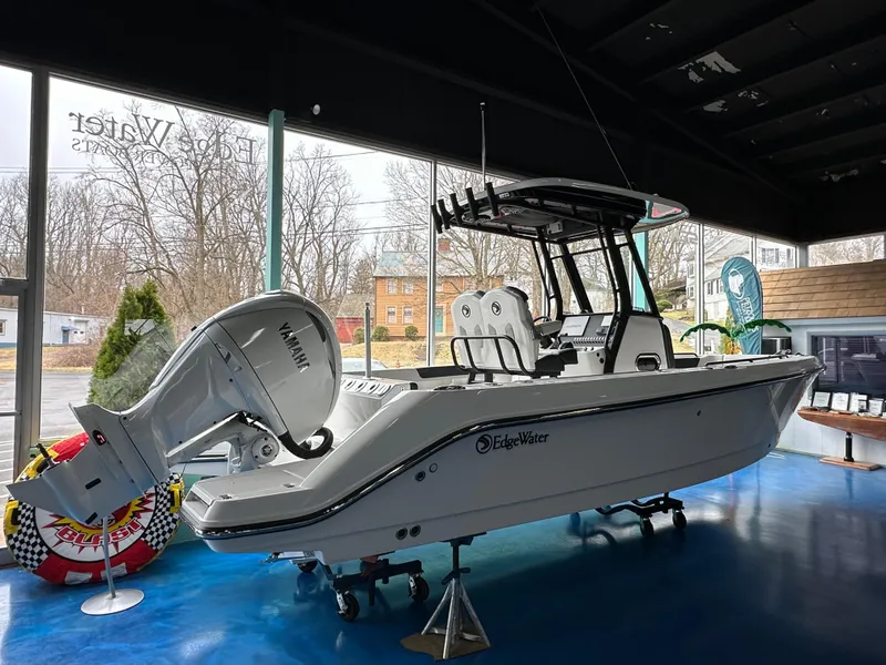 Slide: The Image of 2025 Edgewater 230CC Center Console boat displayed indoors with Yamaha engine. - 4