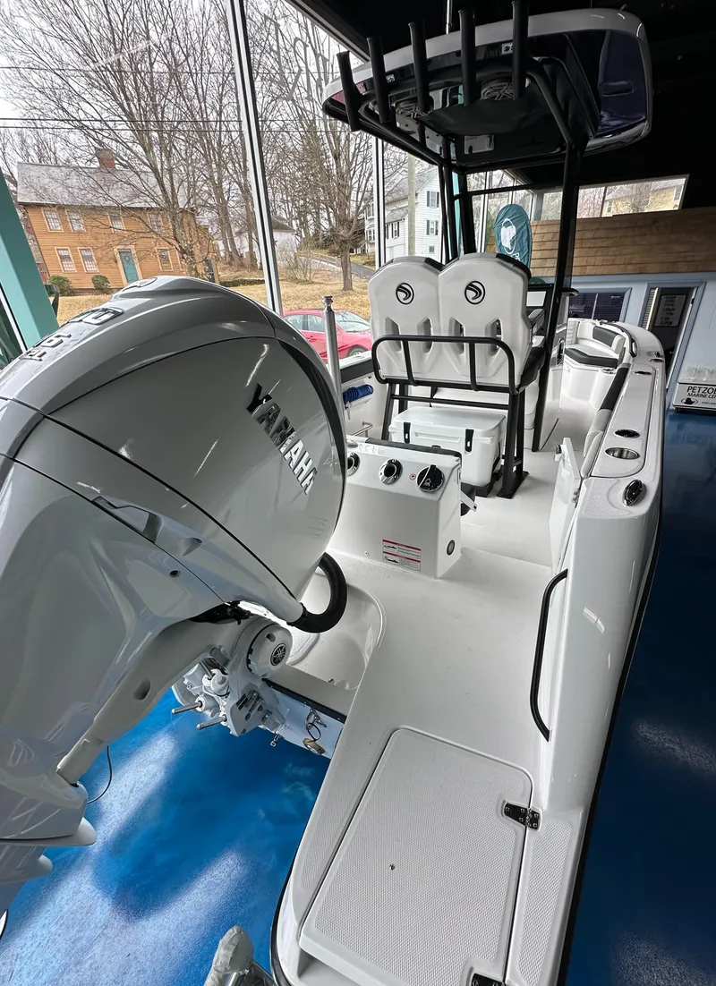 Slide: The Image of 2025 Edgewater 230CC Center Console boat with Yamaha engine, showcased indoors. - 7