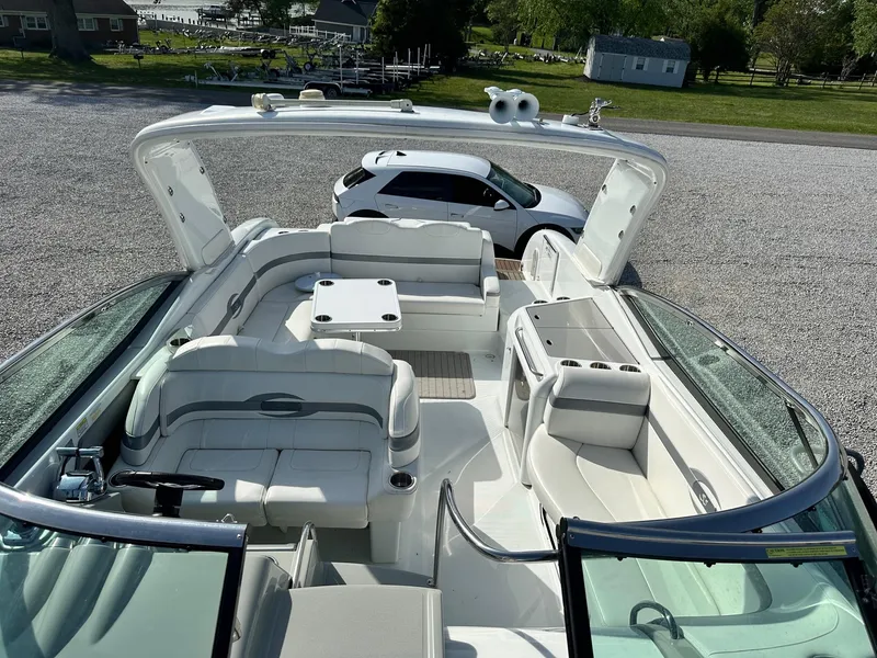 Slide: The Image of 2012 Formula 350 Sun Sport boat with spacious seating and sleek design, parked on gravel. - 16