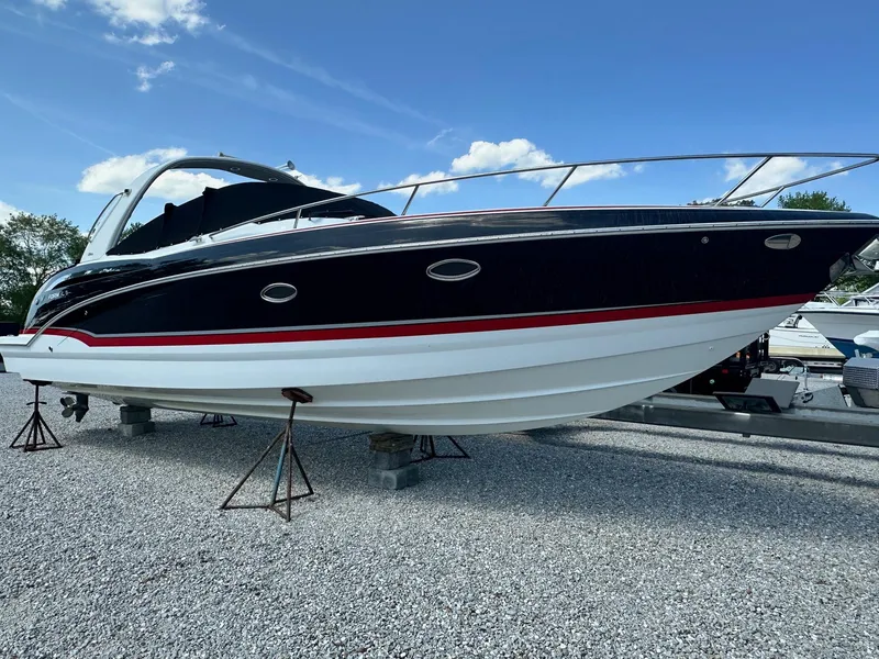 Slide: The Image of 2012 Formula 350 Sun Sport boat on gravel, blue sky background. - 2