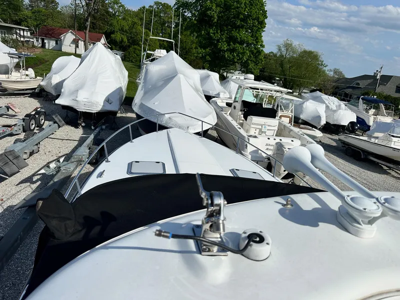 Slide: The Image of 2012 Formula 350 Sun Sport boat in storage, surrounded by covered vessels. - 22