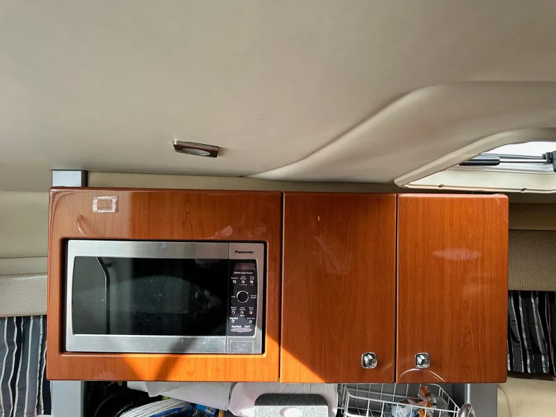 Slide: The Image of 2012 Formula 350 Sun Sport interior with microwave and wooden cabinets. - 27