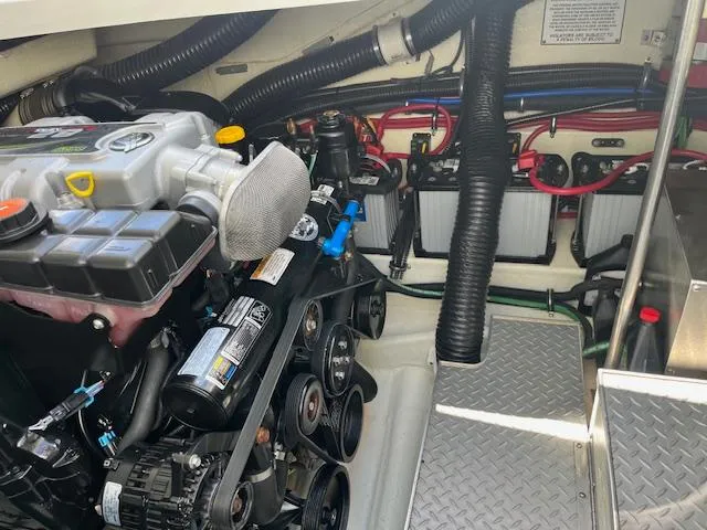 Slide: The Image of Engine compartment of a 2012 Formula 350 Sun Sport boat, showcasing mechanical components. - 38