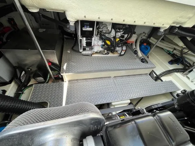 Slide: The Image of Engine compartment of a 2012 Formula 350 Sun Sport boat, featuring mechanical components and metal flooring. - 39