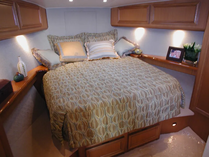 Slide: The Image of Luxurious bedroom in 2024 Jersey Cape 44' Custom yacht with cozy bedding and elegant decor. - 6