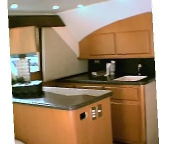 Slide: The Image of 2024 Jersey Cape 44' Custom yacht interior kitchen with modern cabinetry and countertops. - 8