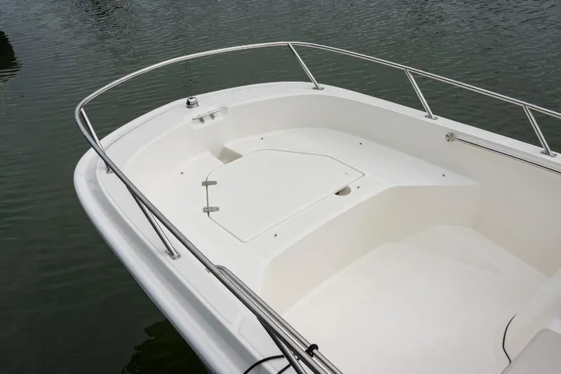 Slide: The Image of 2023 Boston Whaler 160 Super Sport bow area with storage compartment. - 11