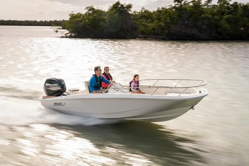 Slide: The Image of 2023 Boston Whaler 160 Super Sport boat cruising on water with three passengers. - 2