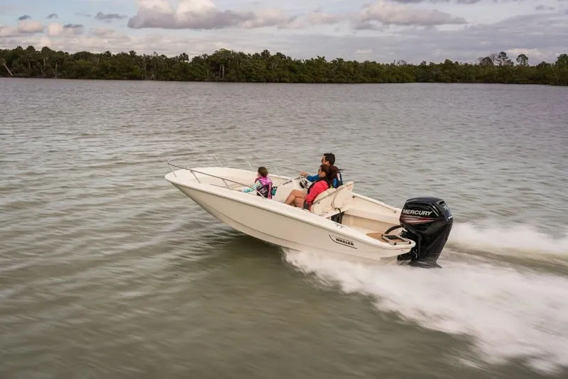 Slide: The Image of 2023 Boston Whaler 160 Super Sport speeding on a lake with passengers. - 6