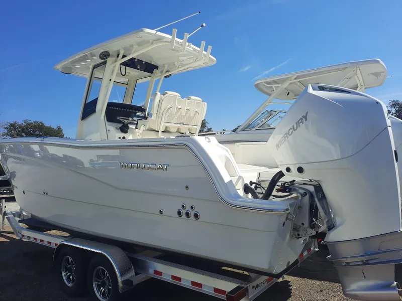 Slide: The Image of 2023 World Cat 260CC-X boat on trailer with Mercury engine, side view. - 1