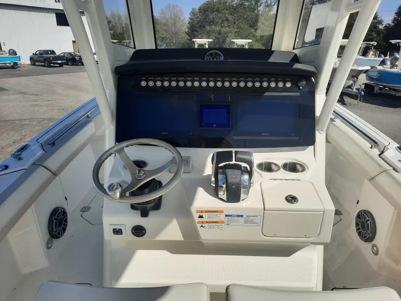 Slide: The Image of 2023 World Cat 260CC-X boat cockpit with steering wheel and control panel. - 4