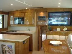 Slide: The Image of 2024 Jersey Cape 48 Custom yacht interior with modern kitchen and entertainment area. - 5