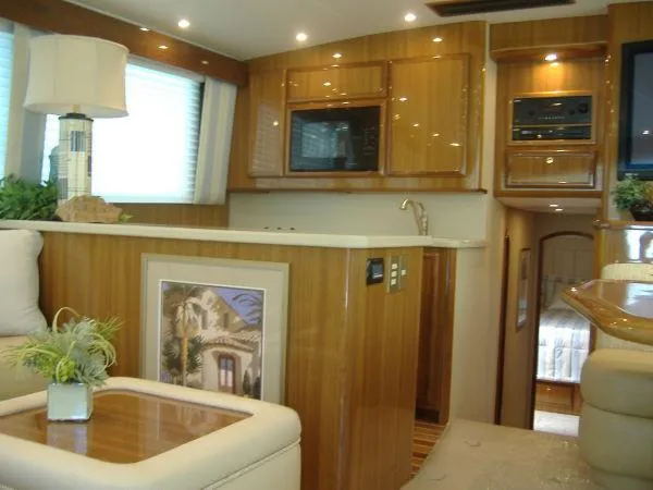 Slide: The Image of 2024 Jersey Cape 48 Custom yacht interior with modern kitchen and cozy seating area. - 6