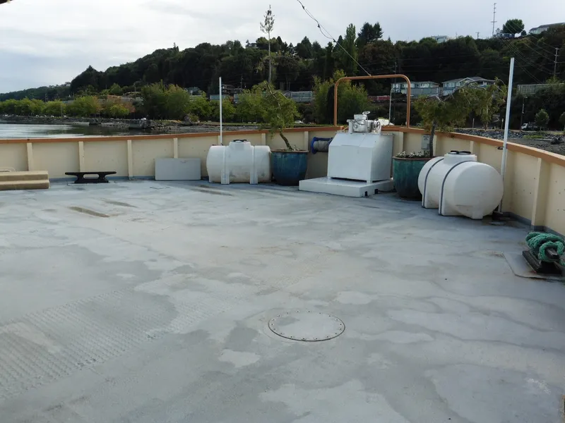 Slide: The Image of 1936 Custom Ferry deck with equipment and scenic shoreline view. - 19