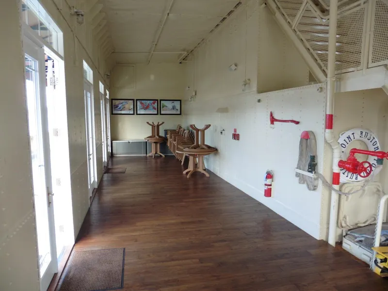 Slide: The Image of Interior of a 1936 custom ferry with wooden floors and safety equipment. - 25