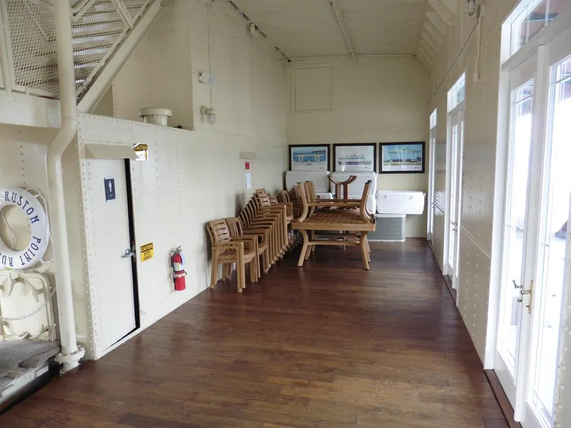 Slide: The Image of Interior of a 1936 custom ferry with wooden chairs and tables stacked. - 26
