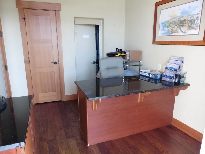 Slide: The Image of Office with wooden furniture, granite desk, and wall art. - 33